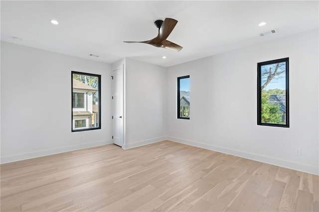 unfurnished room with ceiling fan, light wood-type flooring, and a healthy amount of sunlight