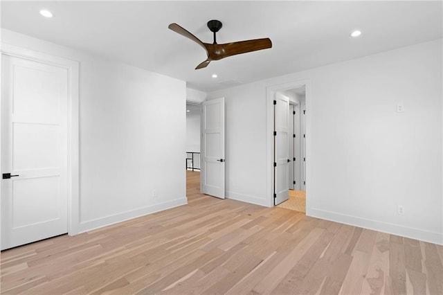 unfurnished bedroom with ceiling fan and light hardwood / wood-style flooring