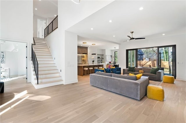 living room featuring ceiling fan and light hardwood / wood-style floors