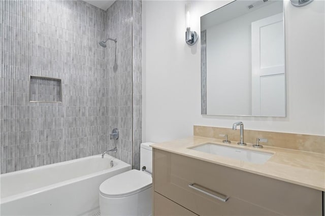 full bathroom featuring toilet, vanity, and tiled shower / bath combo