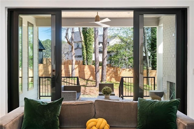 doorway to outside with a wealth of natural light and ceiling fan