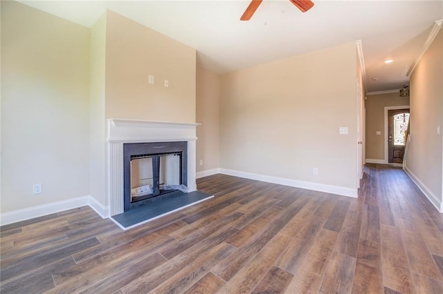 unfurnished living room featuring dark hardwood / wood-style floors, ceiling fan, and crown molding