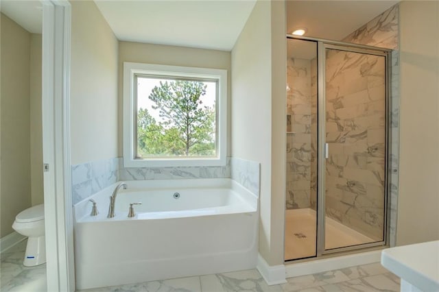 bathroom featuring separate shower and tub and toilet