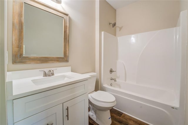 full bathroom featuring hardwood / wood-style flooring, vanity, toilet, and bathtub / shower combination