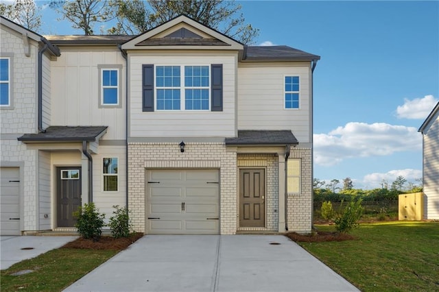 multi unit property featuring a garage and a front yard