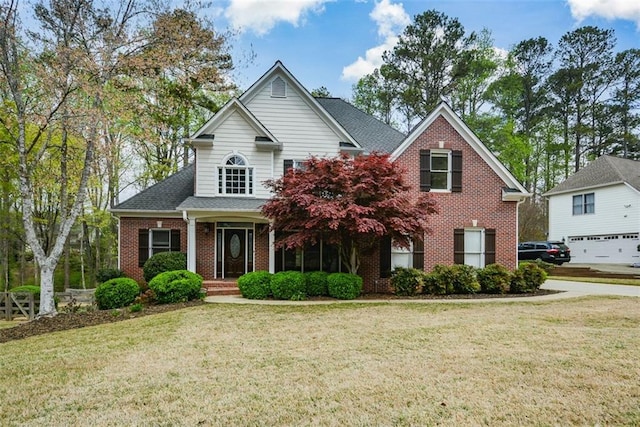 204 Maple Creek Chase, Woodstock, GA 30188 - view of front facade with roof with shingles, brick siding, and a front lawn