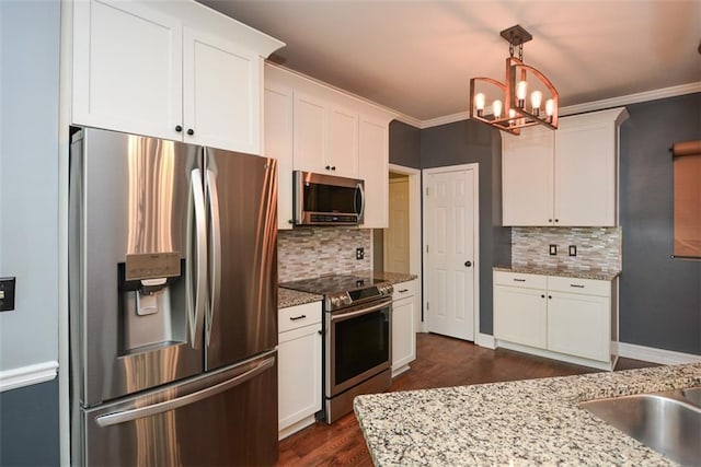 204 Maple Creek Chase, Woodstock, GA 30188 - kitchen with crown molding, white cabinets, appliances with stainless steel finishes, and a chandelier