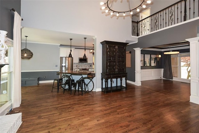 204 Maple Creek Chase, Woodstock, GA 30188 - dining space with dark wood-style floors, ornate columns, and ornamental molding