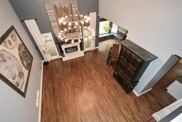 204 Maple Creek Chase, Woodstock, GA 30188 - interior space with a fireplace with raised hearth, a notable chandelier, wood finished floors, and a towering ceiling