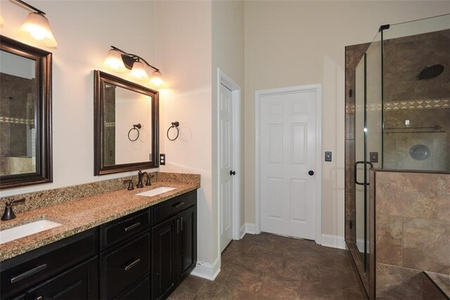 204 Maple Creek Chase, Woodstock, GA 30188 - bathroom with a shower stall, double vanity, baseboards, and a sink