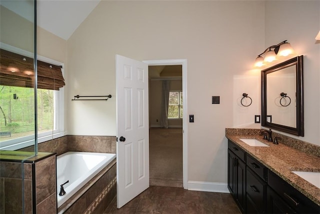204 Maple Creek Chase, Woodstock, GA 30188 - bathroom featuring a sink, double vanity, a garden tub, and lofted ceiling