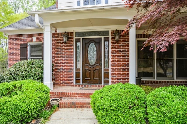 204 Maple Creek Chase, Woodstock, GA 30188 - doorway to property featuring brick siding, a porch, and roof with shingles