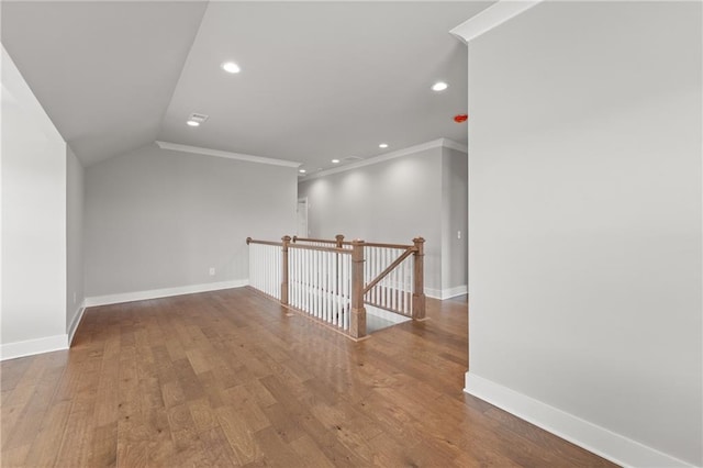 unfurnished room with baseboards, wood finished floors, and ornamental molding