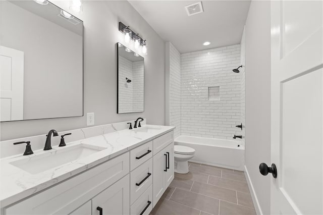 full bath with double vanity, visible vents, tile patterned flooring, and a sink