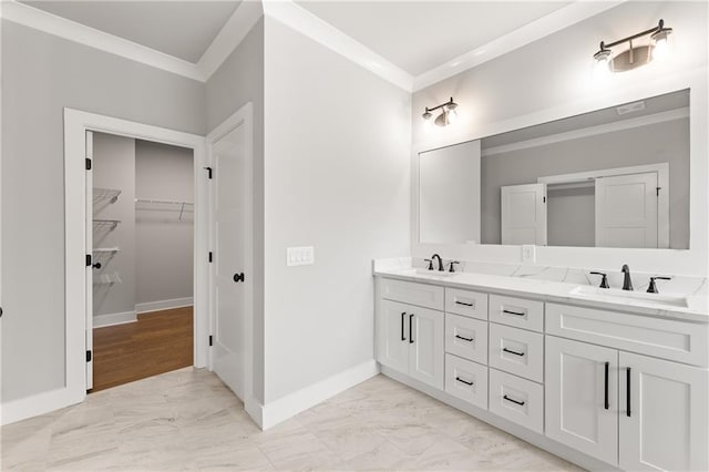 bathroom featuring a sink, marble finish floor, and ornamental molding