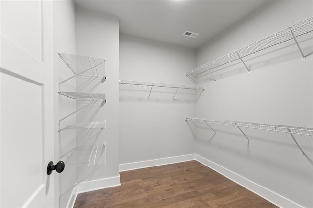 walk in closet featuring visible vents and wood finished floors