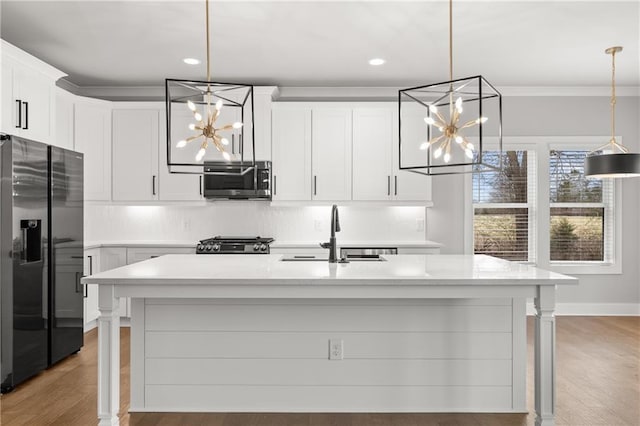 kitchen with a sink, an inviting chandelier, stainless steel fridge with ice dispenser, decorative backsplash, and range