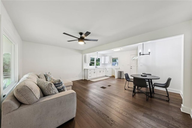 16064 Hopewell Rd, Alpharetta, GA 30004 - living area featuring dark wood-style flooring, ceiling fan, a chandelier, and baseboards