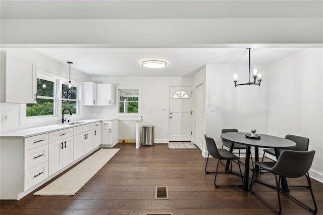 16064 Hopewell Rd, Alpharetta, GA 30004 - kitchen with a sink, dark wood-style flooring, a chandelier, white cabinets, and light countertops