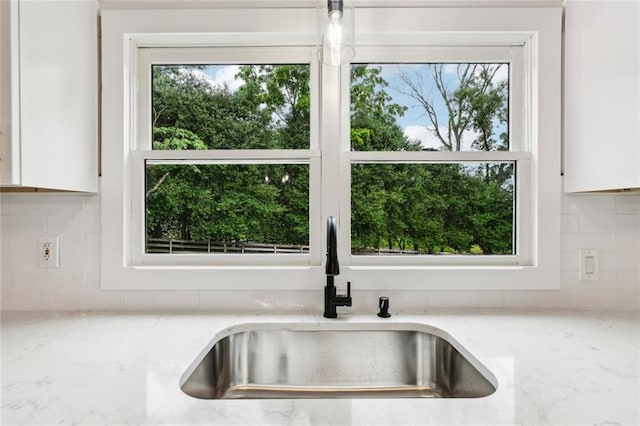 16064 Hopewell Rd, Alpharetta, GA 30004 - kitchen view of a sink, white cabinets, and decorative backsplash