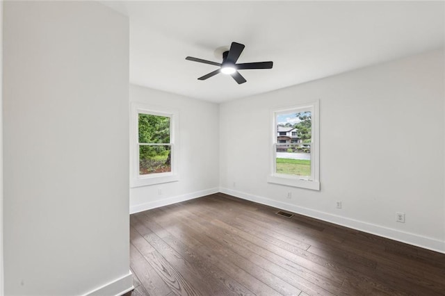 16064 Hopewell Rd, Alpharetta, GA 30004 - spare room with healthy amount of natural light, dark wood-style floors, baseboards, and ceiling fan