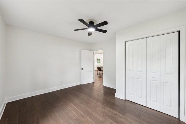 16064 Hopewell Rd, Alpharetta, GA 30004 - unfurnished bedroom with dark wood-style flooring, baseboards, a closet, and a ceiling fan