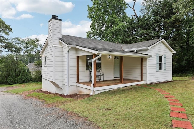 16064 Hopewell Rd, Alpharetta, GA 30004 - ranch-style house with covered porch, a chimney, a front yard, and a shingled roof