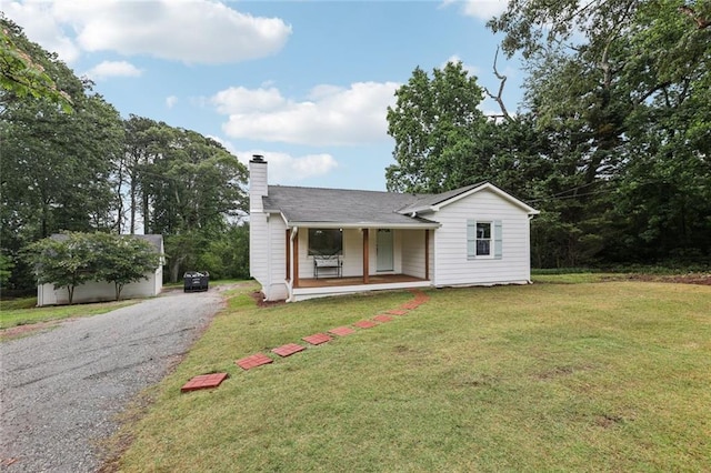 16064 Hopewell Rd, Alpharetta, GA 30004 - view of front of property with covered porch, a chimney, a front yard, and gravel driveway