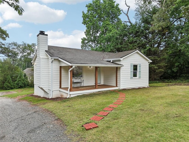 16064 Hopewell Rd, Alpharetta, GA 30004 - single story home featuring a porch, a chimney, a front yard, and a shingled roof