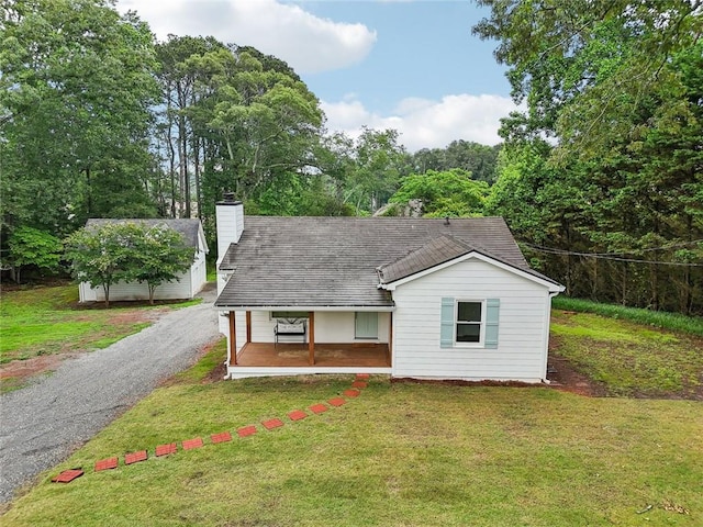 16064 Hopewell Rd, Alpharetta, GA 30004 - view of front facade featuring a front lawn, covered porch, and a chimney