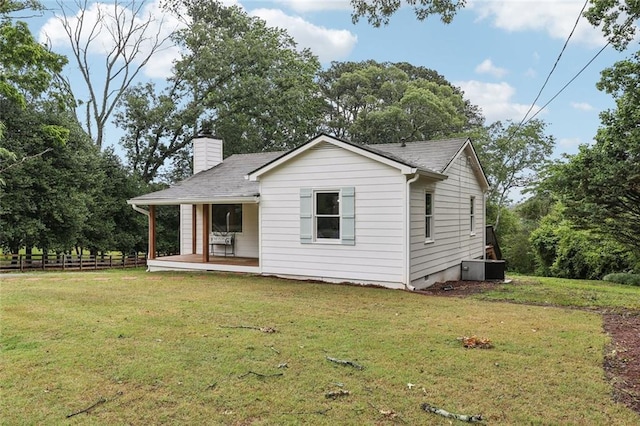 16064 Hopewell Rd, Alpharetta, GA 30004 - back of property with a chimney, covered porch, crawl space, central AC, and view of scattered trees