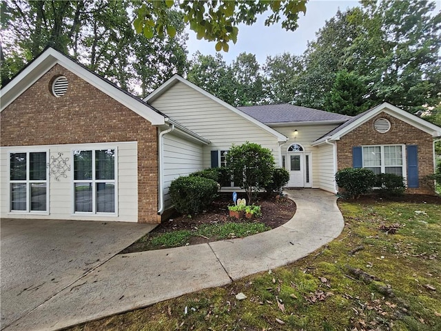 ranch-style home featuring brick siding