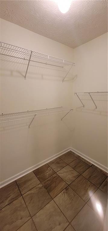 spacious closet featuring tile patterned floors