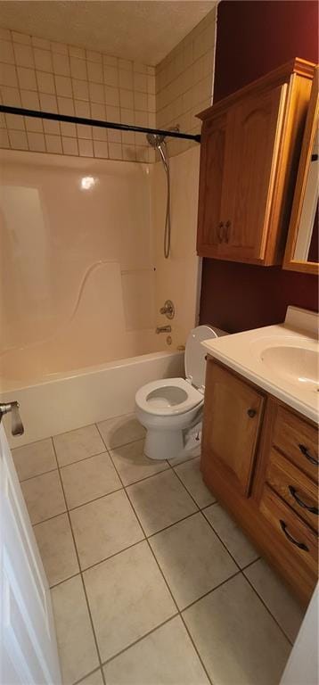 bathroom featuring toilet, tile patterned flooring, vanity, and washtub / shower combination