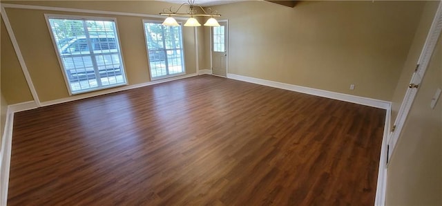 unfurnished dining area with plenty of natural light, dark wood-type flooring, and baseboards