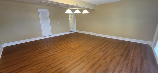 spare room with baseboards and dark wood finished floors