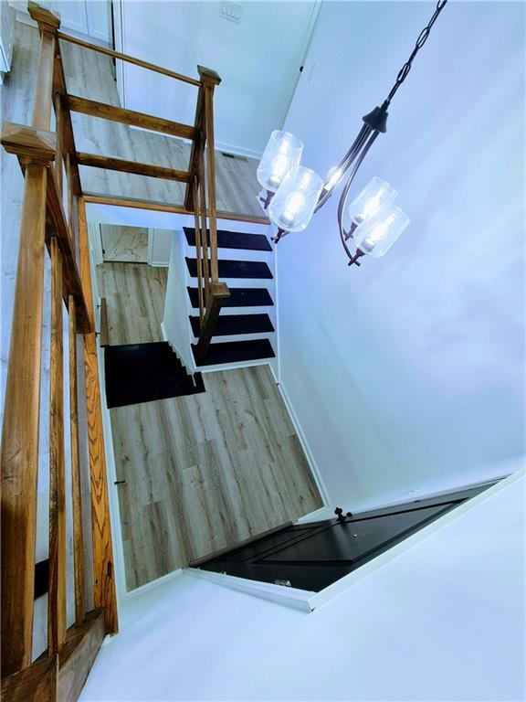 staircase with hardwood / wood-style flooring