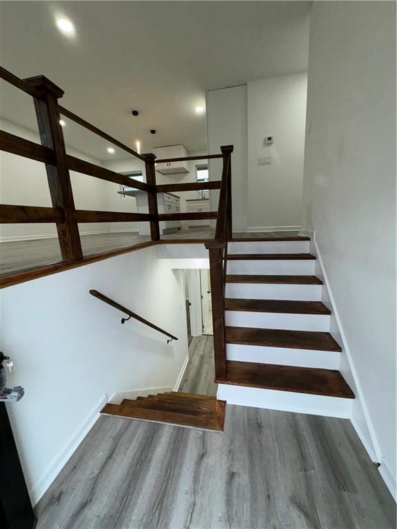 stairs with hardwood / wood-style flooring