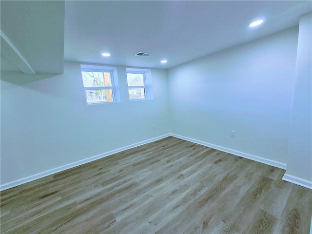 basement with light hardwood / wood-style floors