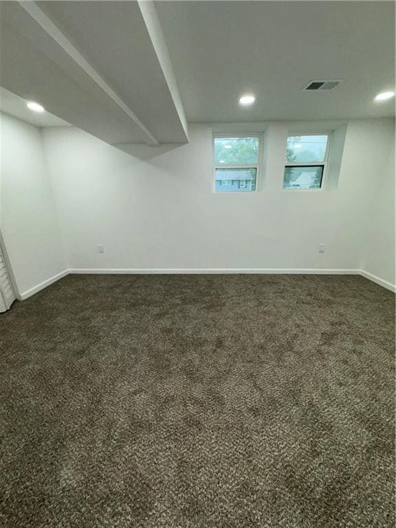 basement featuring dark colored carpet