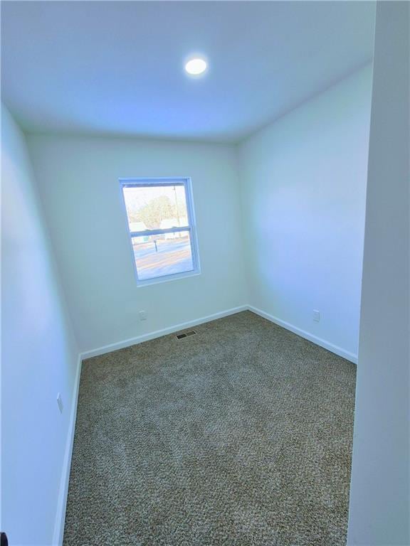 unfurnished room with dark carpet