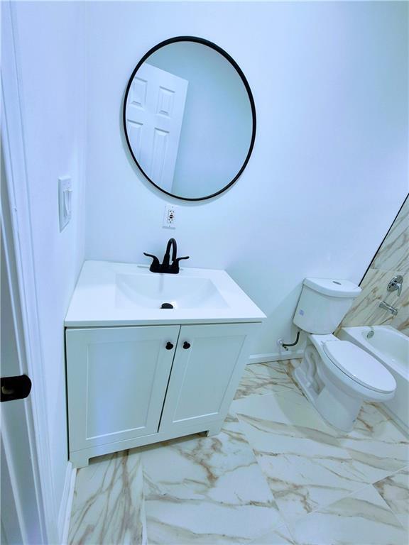 bathroom featuring vanity and toilet