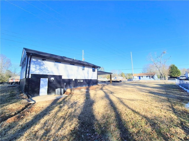 view of side of property with a yard