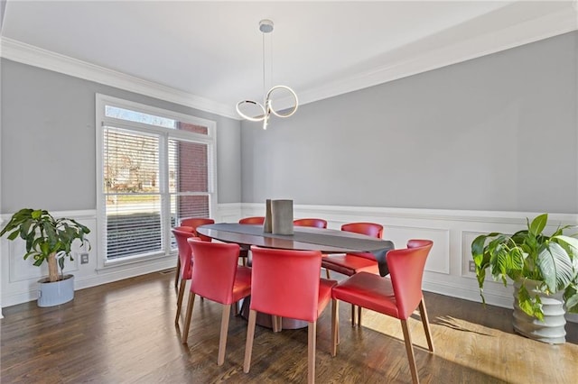 dining room featuring dark hardwood / wood-style flooring, a notable chandelier, and crown molding