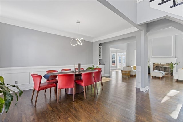 dining area with dark hardwood / wood-style flooring, a notable chandelier, and crown molding