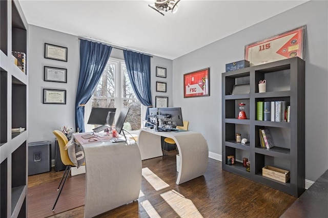 office area with dark wood-type flooring and built in features