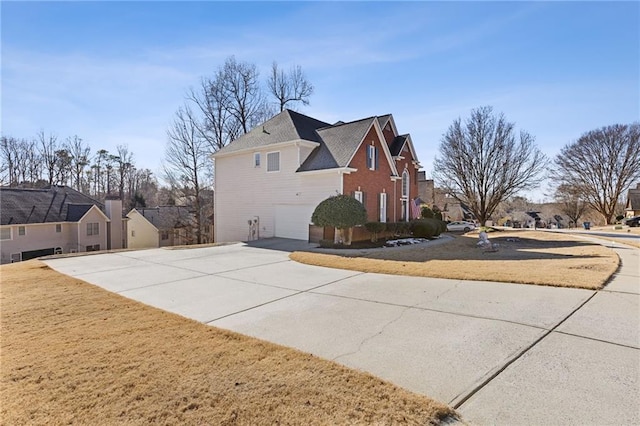 view of side of property with a garage and a lawn