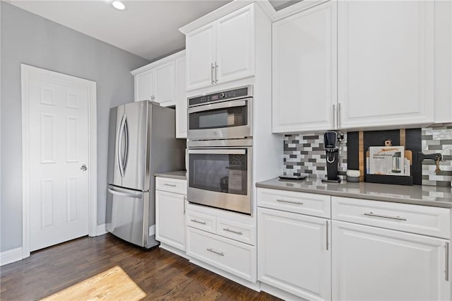 kitchen with tasteful backsplash, dark hardwood / wood-style flooring, stainless steel appliances, and white cabinets