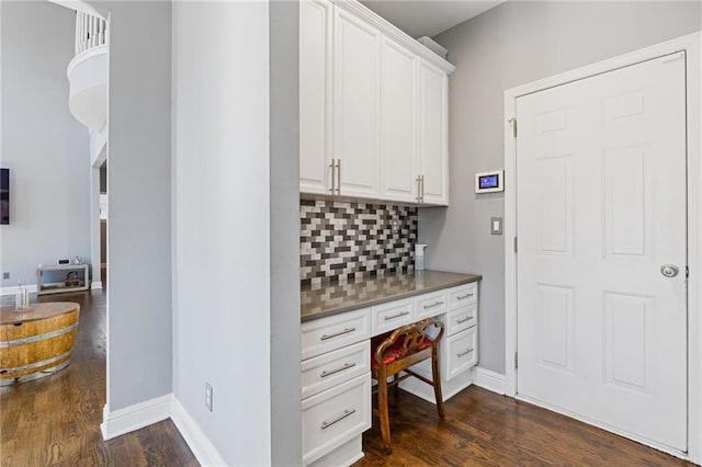 interior space with dark hardwood / wood-style flooring and built in desk