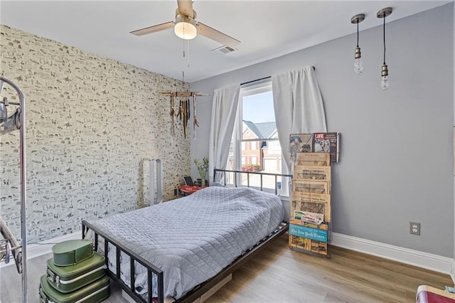 bedroom with hardwood / wood-style flooring and ceiling fan